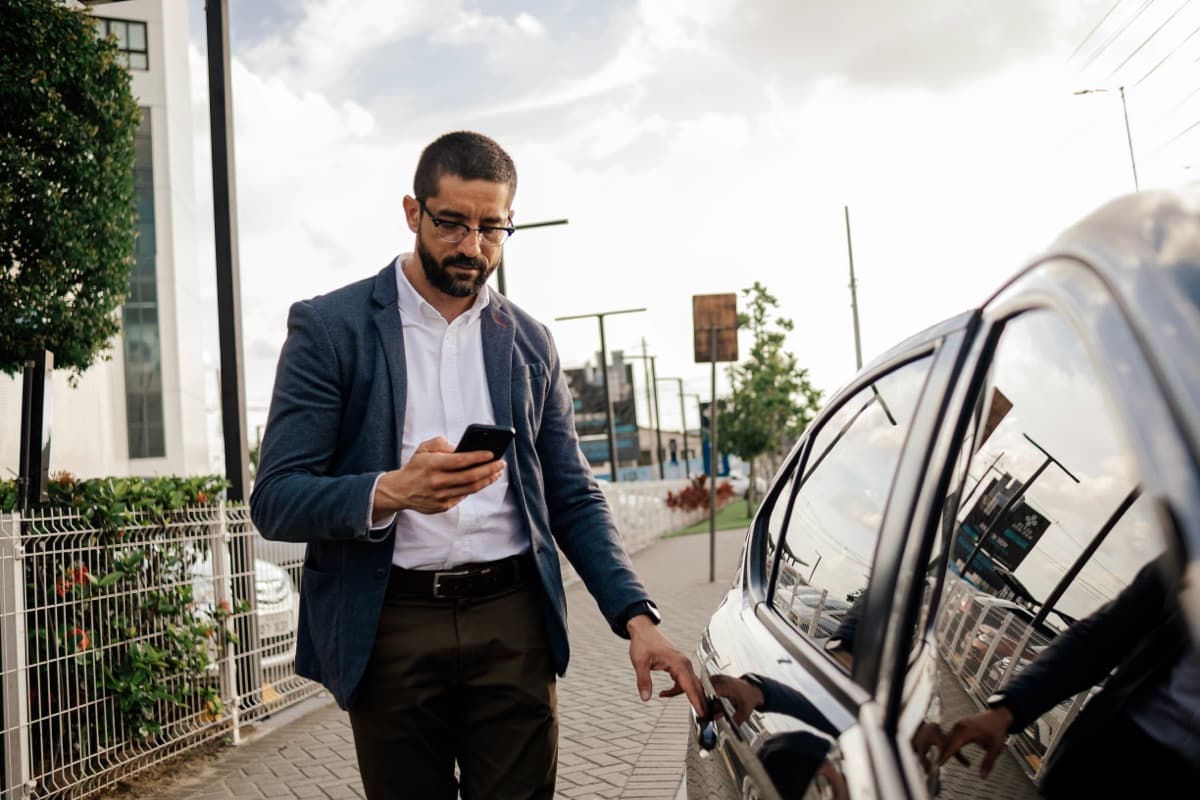 Customer checking their phone as their driver arrives